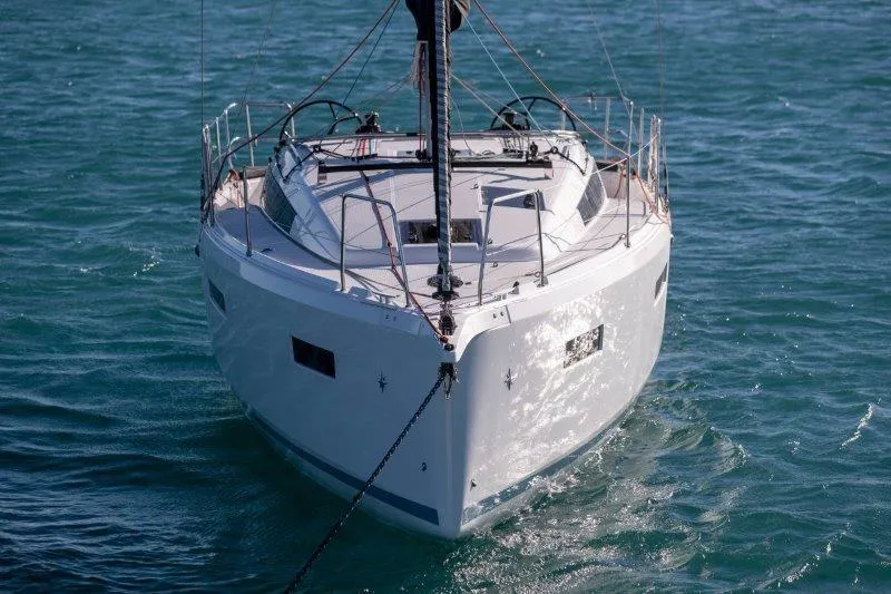 Slide: The Image of 2025 Jeanneau 380 sailboat on calm blue water, front view. - 71