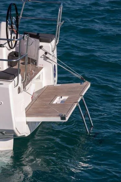 Slide: The Image of 2025 Jeanneau 380 yacht with open swim platform on blue ocean water. - 74