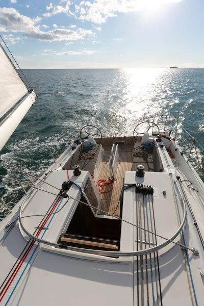 Slide: The Image of 2025 Jeanneau 380 sailboat on open sea, sunny day, dual steering wheels. - 75