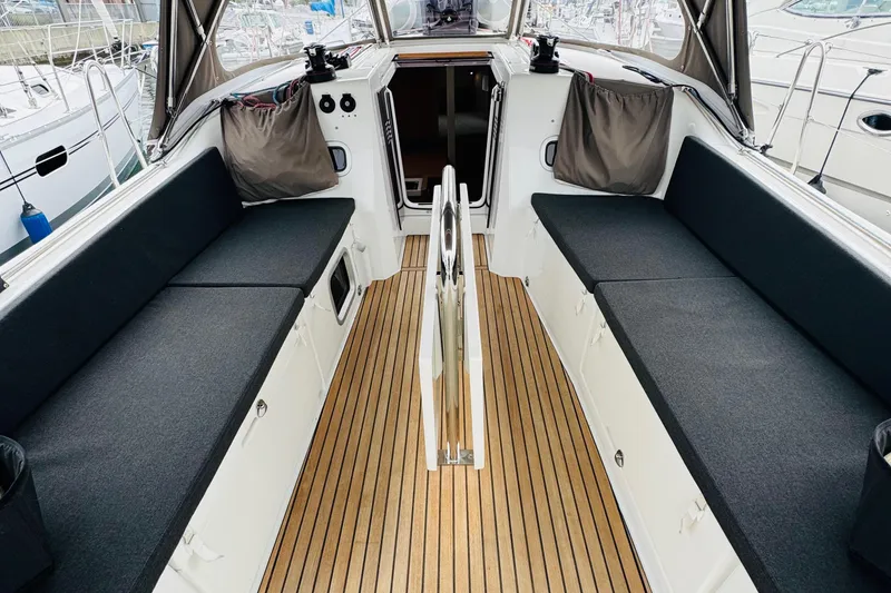 Slide: The Image of 2023 Jeanneau 380 yacht cockpit with sleek seating and teak flooring. - 8