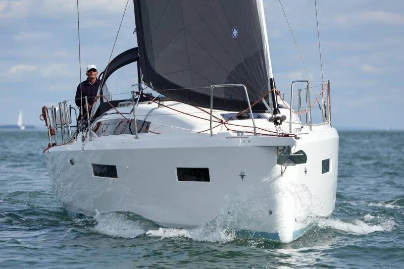 Slide: The Image of 2025 Jeanneau 380 sailboat navigating on open water. - 83