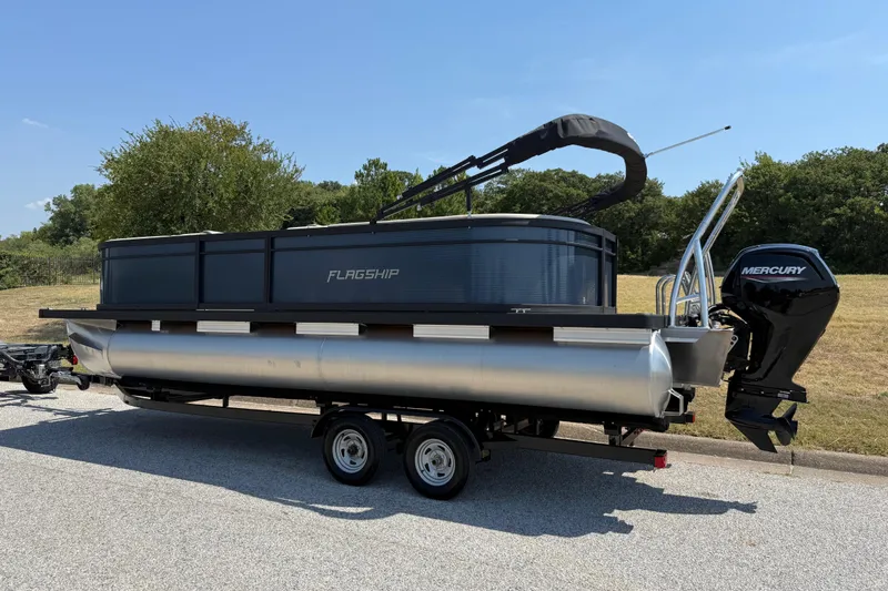Slide: The Image of 2025 Flagship F22CU SPORT TOON pontoon boat on trailer, featuring Mercury outboard motor. - 12