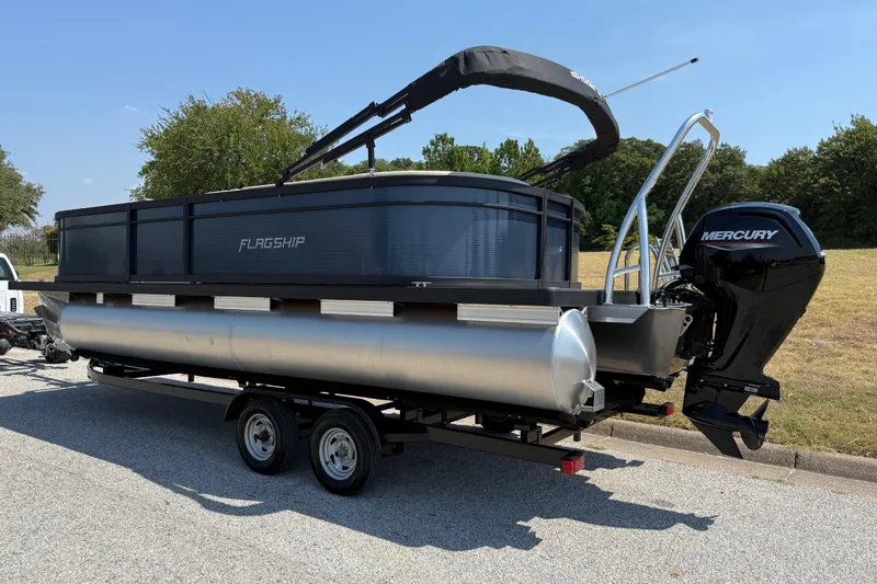Slide: The Image of 2025 Flagship F22CU SPORT TOON pontoon boat with Mercury outboard motor on trailer. - 13
