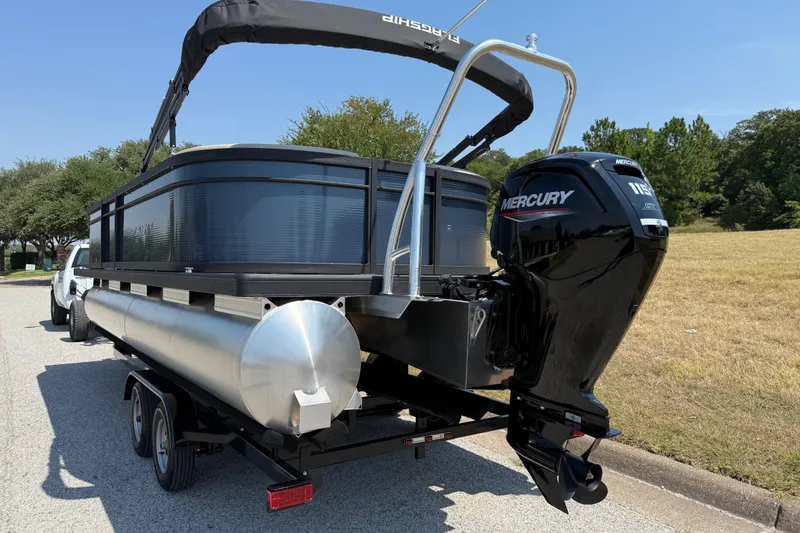 Slide: The Image of 2025 Flagship F22CU SPORT TOON pontoon boat with Mercury outboard motor on trailer. - 15