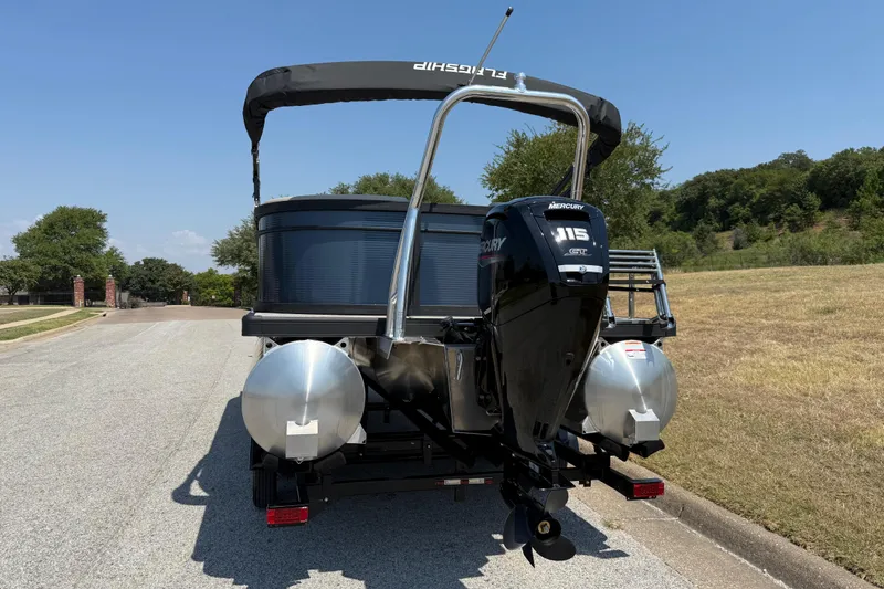 Slide: The Image of 2025 Flagship F22CU SPORT TOON pontoon boat with Mercury 115 outboard motor. - 16