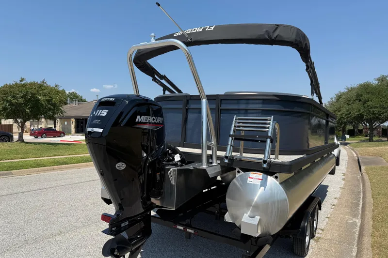 Slide: The Image of 2025 Flagship F22CU SPORT TOON pontoon boat with Mercury 115 engine on a trailer. - 18