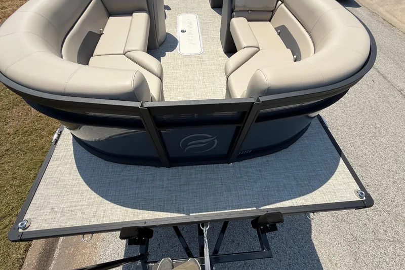 Slide: The Image of 2025 Flagship F22CU SPORT TOON pontoon boat with beige seating and spacious deck. - 22