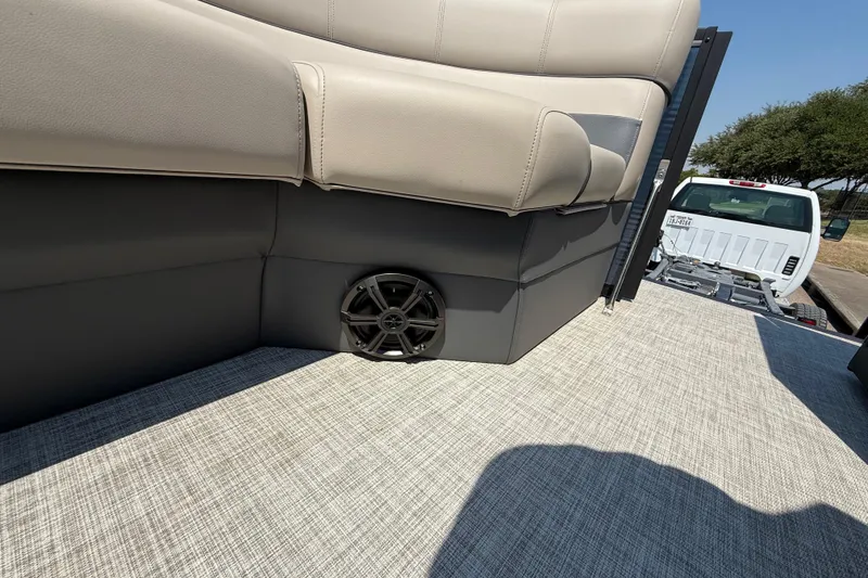 Slide: The Image of 2025 Flagship F22CU SPORT TOON boat interior with beige seating and speaker. - 29