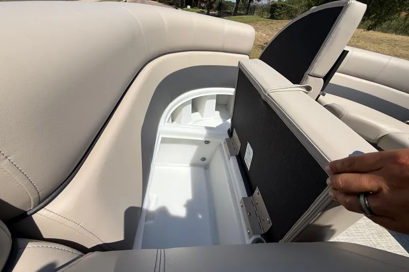 Slide: The Image of 2025 Flagship F22CU SPORT TOON boat seat storage compartment open, showcasing spacious interior. - 32