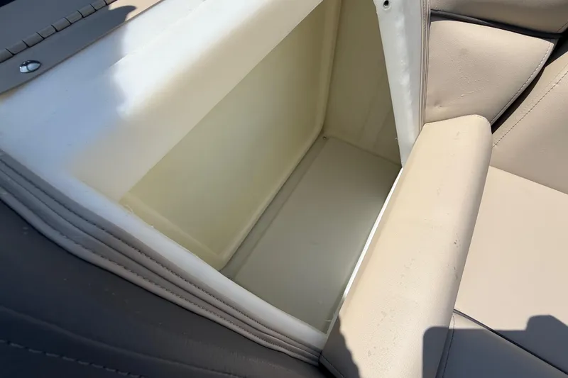 Slide: The Image of Open storage compartment in 2025 Flagship F22CU SPORT TOON boat with beige interior. - 34