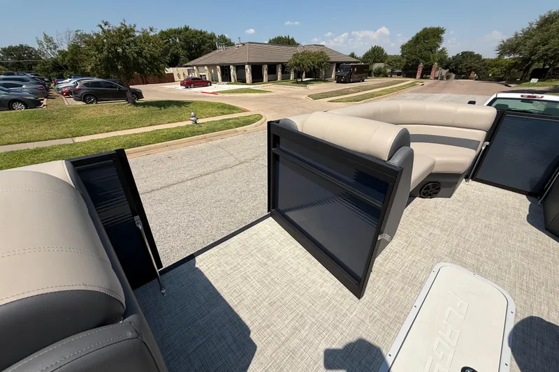 Slide: The Image of 2025 Flagship F22CU SPORT TOON boat interior with beige seating and open gate. - 40