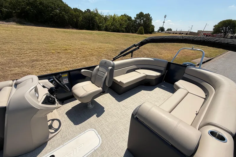 Slide: The Image of 2025 Flagship F22CU SPORT TOON pontoon boat with beige seating and modern helm. - 41