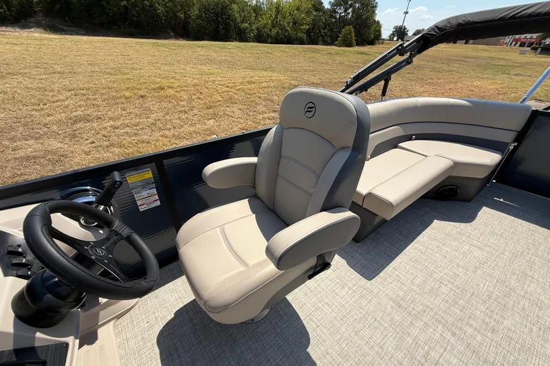 Slide: The Image of Interior of 2025 Flagship F22CU SPORT TOON boat with plush seating and steering wheel. - 44