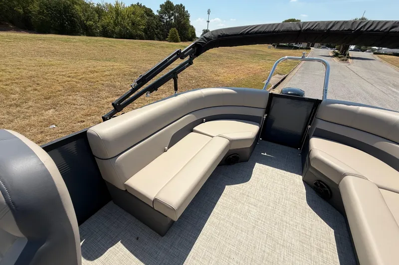 Slide: The Image of 2025 Flagship F22CU SPORT TOON boat interior with beige seating and open deck. - 51