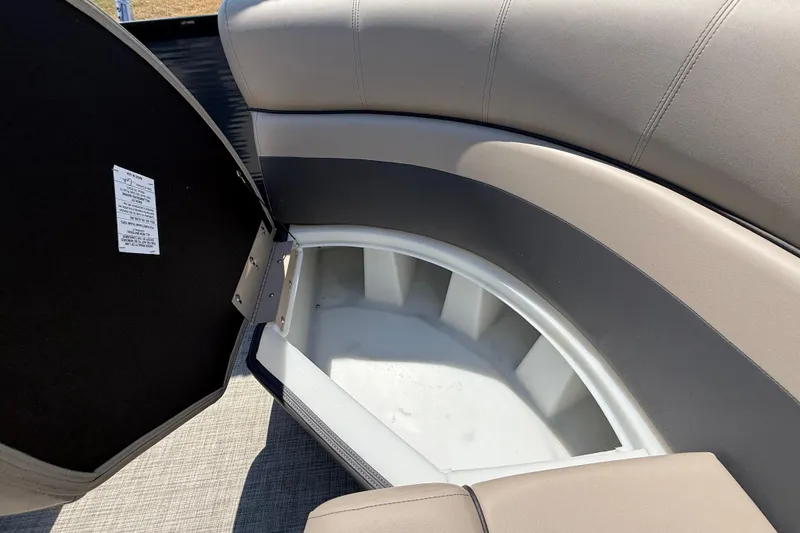 Slide: The Image of Open storage compartment in 2025 Flagship F22CU SPORT TOON boat with cushioned seating. - 56