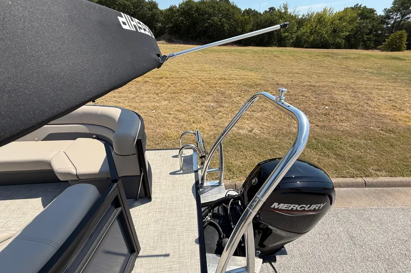 Slide: The Image of 2025 Flagship F22CU SPORT TOON boat with Mercury engine, sleek seating, and canopy. - 61