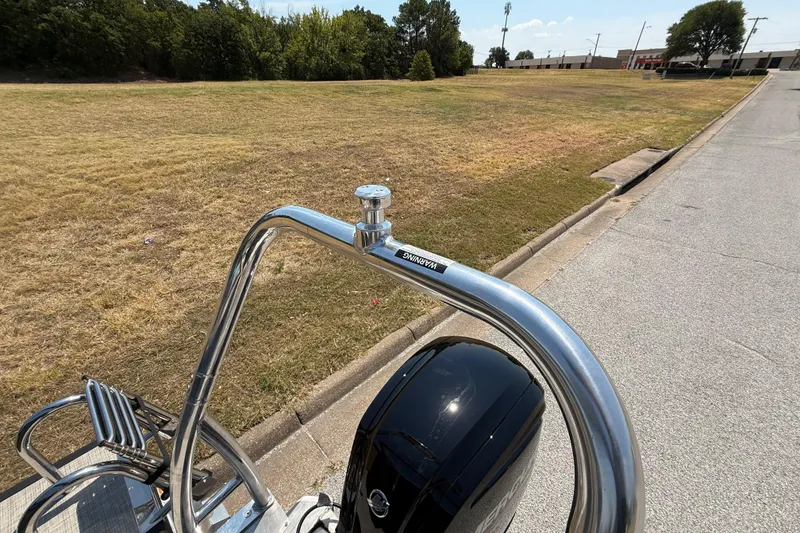 Slide: The Image of Flagship F22CU SPORT TOON boat detail with chrome railing, parked on a sunny day. - 62