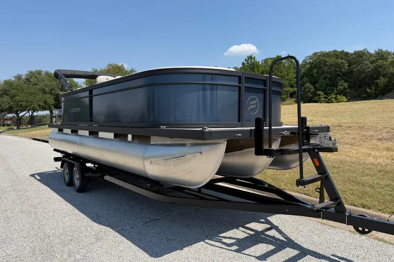 Slide: The Image of 2025 Flagship F22CU SPORT TOON pontoon boat on trailer, parked on a sunny road. - 65