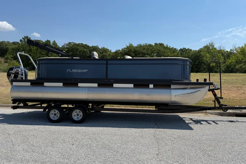 Slide: The Image of 2025 Flagship F22CU SPORT TOON pontoon boat on trailer, parked outdoors. - 69