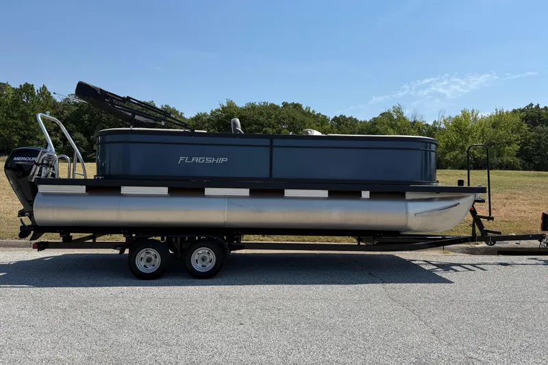 Slide: The Image of 2025 Flagship F22CU SPORT TOON pontoon boat on trailer, parked on roadside. - 70