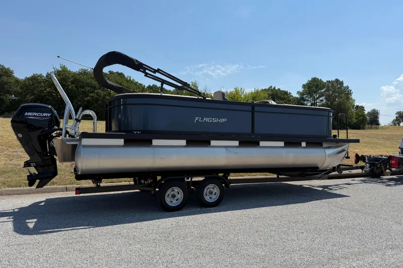 Slide: The Image of 2025 Flagship F22CU SPORT TOON pontoon boat on trailer, parked outdoors. - 72