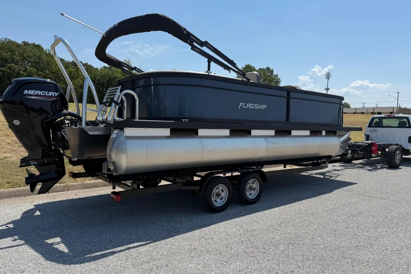 Slide: The Image of 2025 Flagship F22CU SPORT TOON pontoon boat on trailer, featuring Mercury outboard motor. - 73