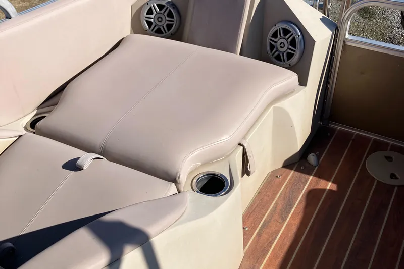 Slide: The Image of 2013 South Bay 724 boat interior with beige seating and wood flooring. - 6