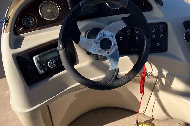 Slide: The Image of Steering console of a 2013 South Bay 724 boat with control panel and gauges. - 8