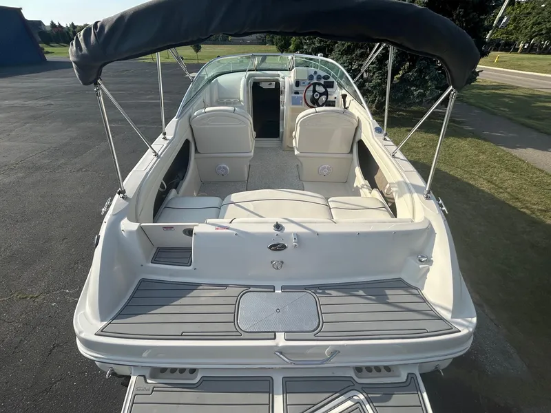 Slide: The Image of 2004 Sea Ray 225 Weekender boat with canopy, viewed from the rear on a sunny day. - 10