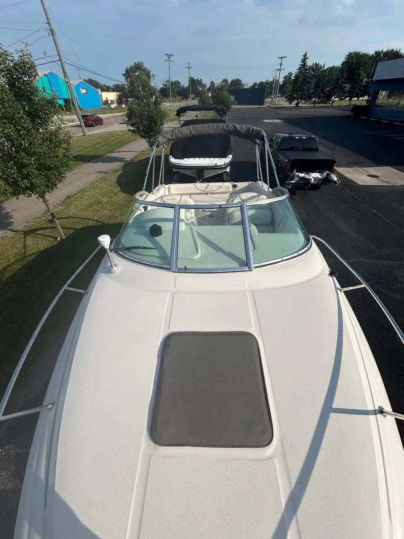 Slide: The Image of 2004 Sea Ray 225 Weekender boat parked on a street, viewed from above. - 11