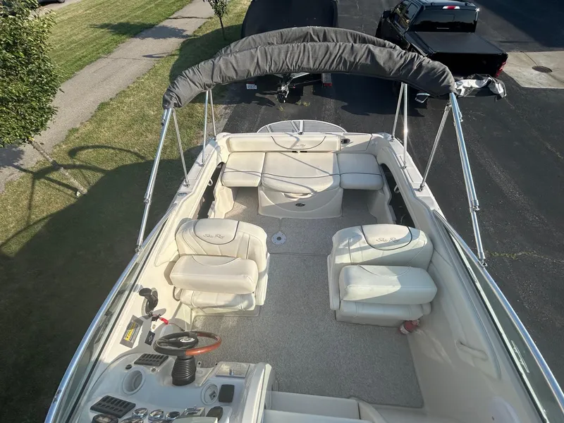 Slide: The Image of 2004 Sea Ray 225 Weekender boat interior with seating and steering console. - 13