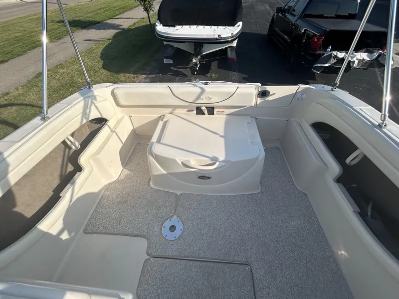 Slide: The Image of 2004 Sea Ray 225 Weekender boat interior with seating and storage compartments. - 15
