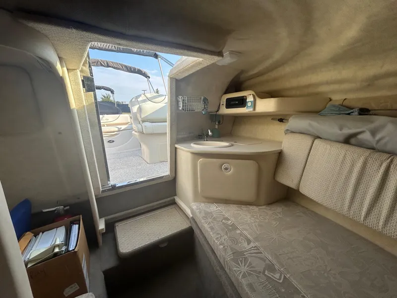 Slide: The Image of Interior of 2004 Sea Ray 225 Weekender boat with seating and compact kitchenette. - 20