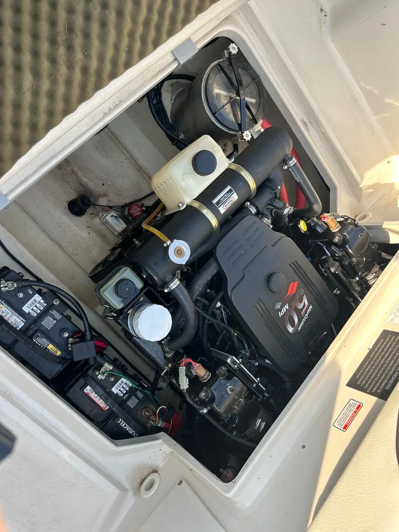 Slide: The Image of Engine compartment of a 2004 Sea Ray 225 Weekender boat, featuring a MerCruiser engine. - 21