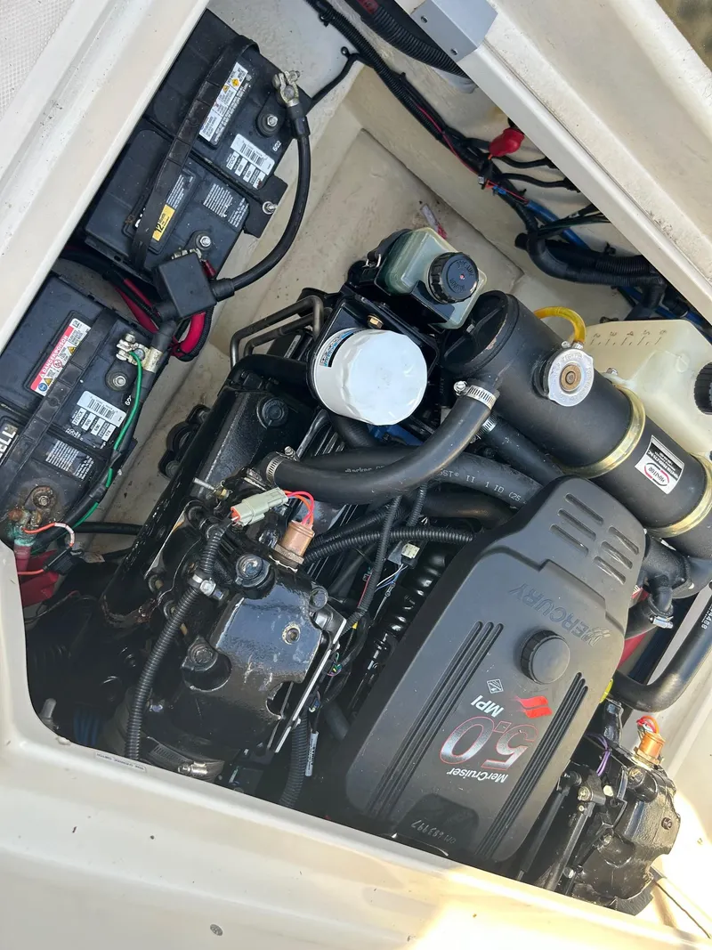 Slide: The Image of Engine compartment of a 2004 Sea Ray 225 Weekender boat, featuring batteries and wiring. - 22