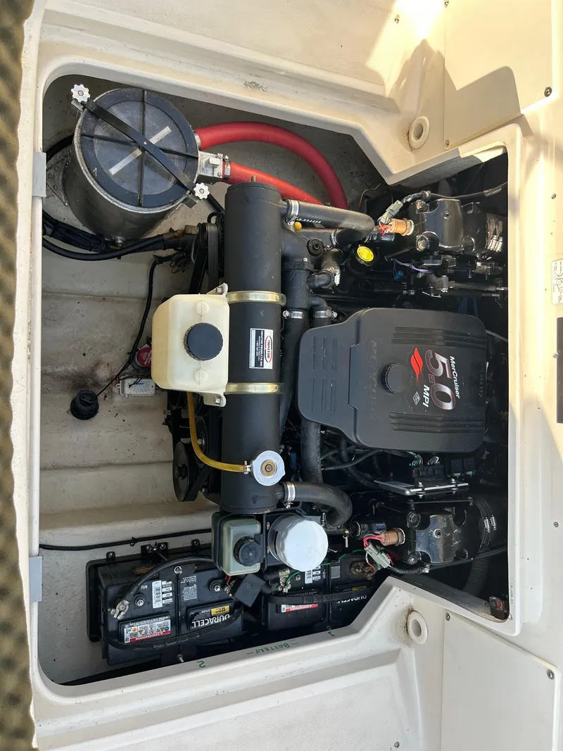 Slide: The Image of Engine compartment of a 2004 Sea Ray 225 Weekender boat, showcasing the motor and components. - 23