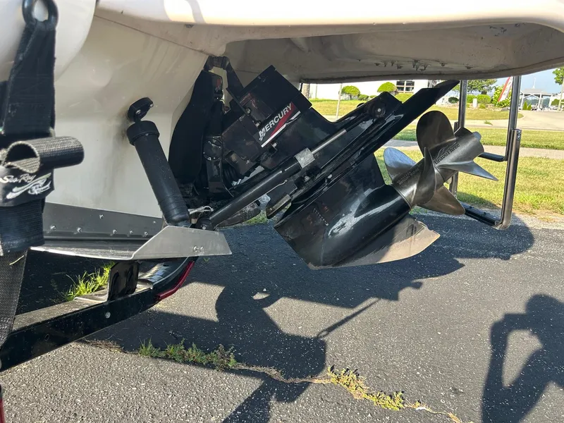 Slide: The Image of 2004 Sea Ray 225 Weekender boat propeller and outdrive on a sunny day. - 24