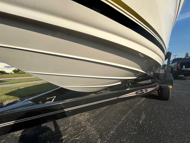 Slide: The Image of 2004 Sea Ray 225 Weekender boat on trailer, close-up view of hull and branding. - 27