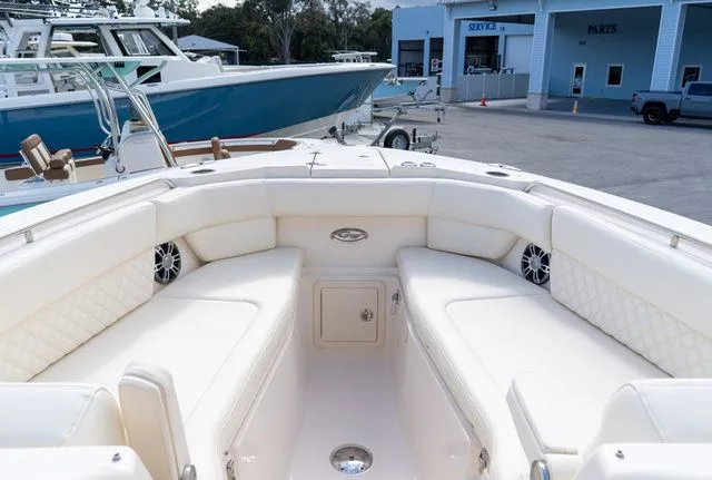 Slide: The Image of 2024 Grady-White Freedom 307 boat interior with white seating and speakers. - 35