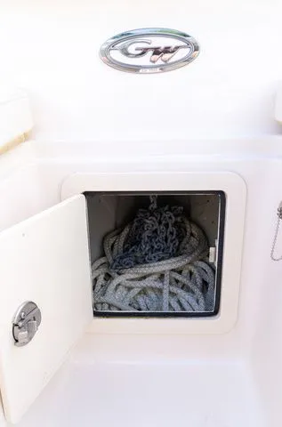 Slide: The Image of 2024 Grady-White Freedom 307 boat storage compartment with coiled rope. - 36