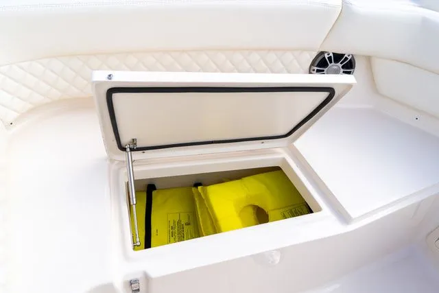 Slide: The Image of 2024 Grady-White Freedom 307 boat storage compartment with yellow life jackets. - 39