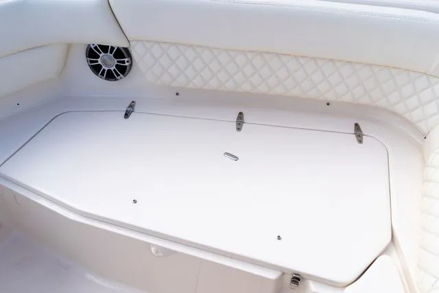 Slide: The Image of 2024 Grady-White Freedom 307 boat interior with white cushioned seating and speaker. - 41
