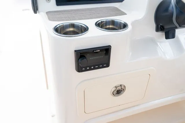 Slide: The Image of 2024 Grady-White Freedom 307 boat console with cup holders and audio controls. - 44