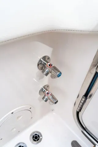 Slide: The Image of 2024 Grady-White Freedom 307 boat interior with stainless steel fixtures and controls. - 47