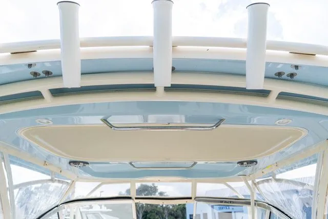 Slide: The Image of 2024 Grady-White Freedom 307 boat roof with rod holders and sleek design. - 48