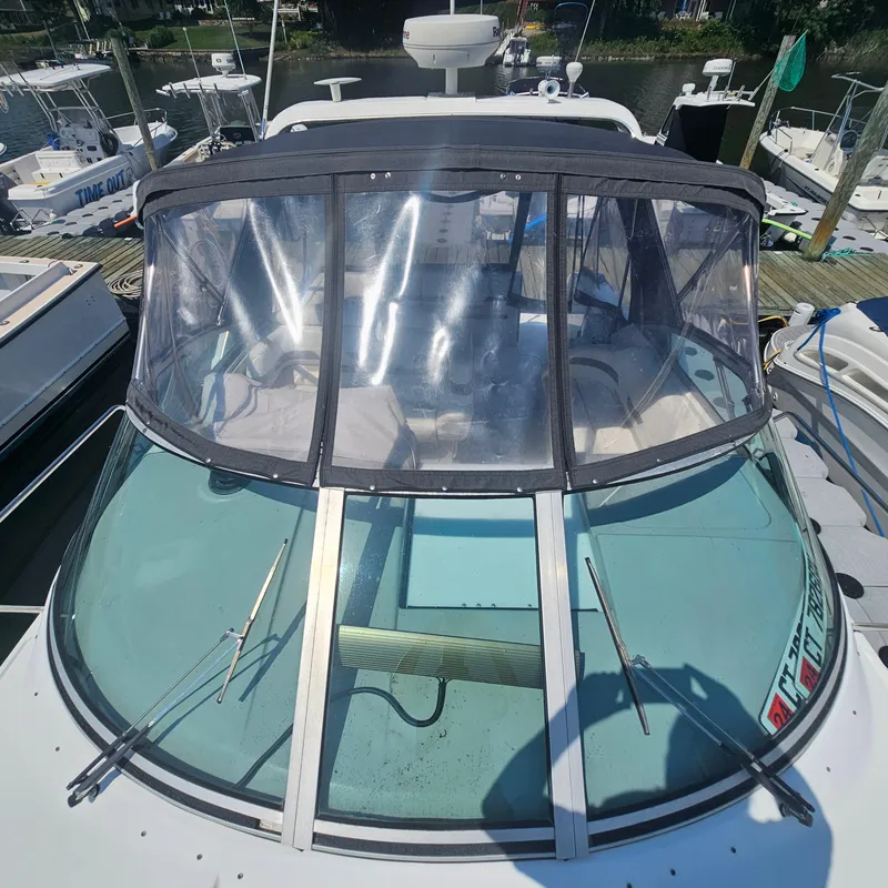Slide: The Image of 2000 Formula 31 PC boat with clear cockpit cover docked at marina. - 10