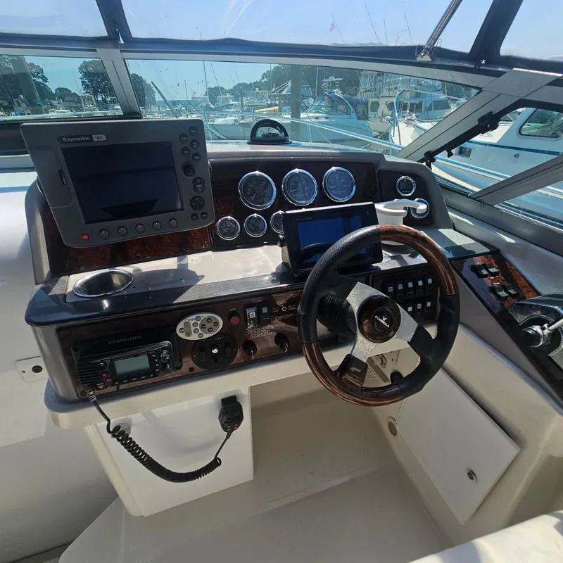Slide: The Image of Control panel of a 2000 Formula 31 PC boat with navigation equipment and steering wheel. - 11