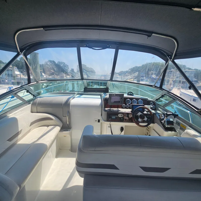 Slide: The Image of Interior view of 2000 Formula 31 PC boat cockpit with steering wheel and seating. - 13