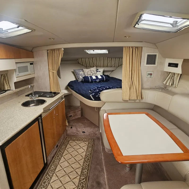 Slide: The Image of Interior of a 2000 Formula 31 PC boat with kitchen, seating, and bed area. - 16
