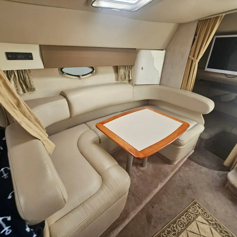 Slide: The Image of Interior of 2000 Formula 31 PC yacht with beige leather seating and wooden table. - 18